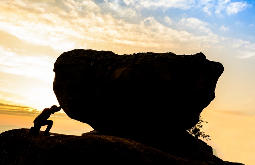 htdocs images Man pushing big rock.RSZ